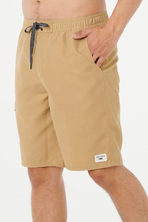 A model wears the Rip Curl Classic Surf Cargo Short in a relaxed fit, one hand in the pocket, shown from mid-torso to mid-thigh against a plain white background.