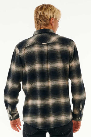 A person with blond hair is shown from the back, wearing a Rip Curl Count Flannel Shirt in black and white against a plain light background.