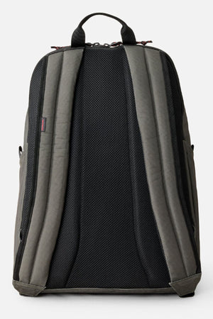 The Rip Curl Crusha 30L Search Backpack in grey and black is shown from the back with padded, adjustable shoulder straps and a breathable back panel—ideal for travel or use as a laptop backpack.