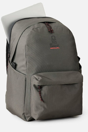 The Rip Curl Crusha 30L Search Backpack in gray features a front pocket, red accents, and a spacious main compartment that fits a laptop—making it the perfect laptop backpack.