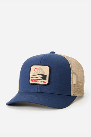 The Rip Curl Custom Curve Trucker hat features a blue and beige design, curved peak, mesh back, and a front patch with a wave, sun, and "RIPCURL" in red. Made from cotton twill, it's shown against a plain white background.