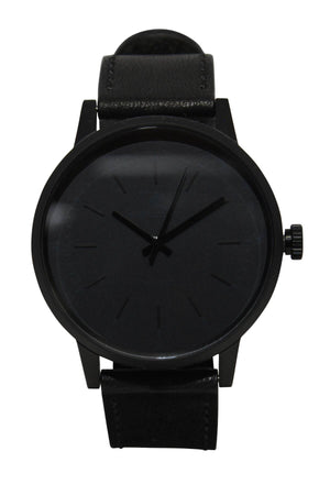 The Rip Curl Drake Midnight Leather Watch, with a minimalist design, features a black leather strap and dial, subtle hour markers, no numerals, and is shown on a white background.