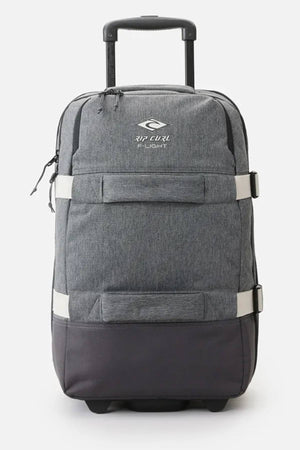 The Rip Curl F-Light 45L Classic Surf Transit Bag in gray features a sleek design with a "Rip Curl Flight" logo, retractable handle, and two wheels. Made from recycled polyester, it includes horizontal straps for added security and provides a minimalist yet durable travel solution.