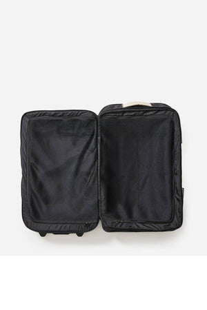 The Rip Curl F-Light Global 100L Soleil Travel Bag is open and empty against a white background, flaunting its interior lined with recycled polyester. Compression straps crisscross the spacious black suitcase, keeping contents secure for your adventures.