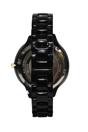 The Rip Curl Horizon Acetate Watch is shown from the back, highlighting its glossy black linked strap, the watch case’s back, and a gold-toned crown—evoking the precision of a Swiss Parts jewelled movement.