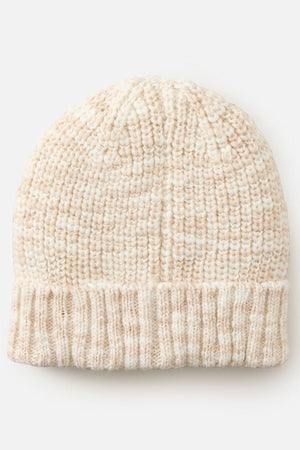 The Rip Curl Keep Sakes Reg Beanie is a cream-colored, ribbed knit hat with a folded brim, ideal for coastal adventures and shown on a plain light background.
