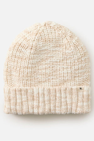 The Rip Curl Keep Sakes Reg Beanie, featuring cream and beige ribbed knit, a thick fold-over cuff, and a small metal tag on the brim, is shown against a plain white background—ideal for coastal adventures.