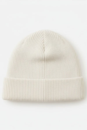 The Rip Curl Oceanic Reg Beanie is a plain, light beige ribbed knit beanie with a folded brim, shown flat on a white background—ideal cozy headwear for after water sports adventures.