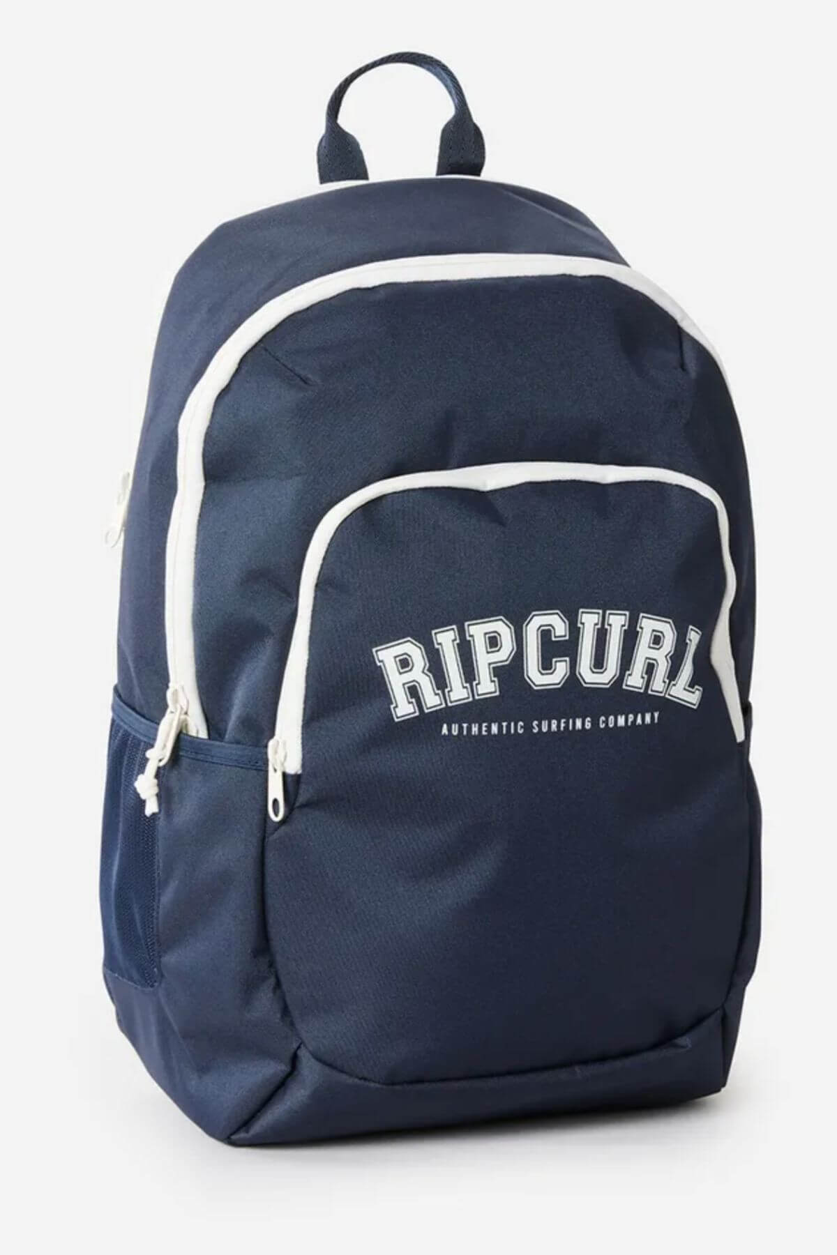 The Rip Curl Ozone 2.0 30L Backpack is navy blue with white zippers, trim, front and side mesh pockets, a laptop section, and "RIP CURL AUTHENTIC SURFING COMPANY" printed in white on the front.