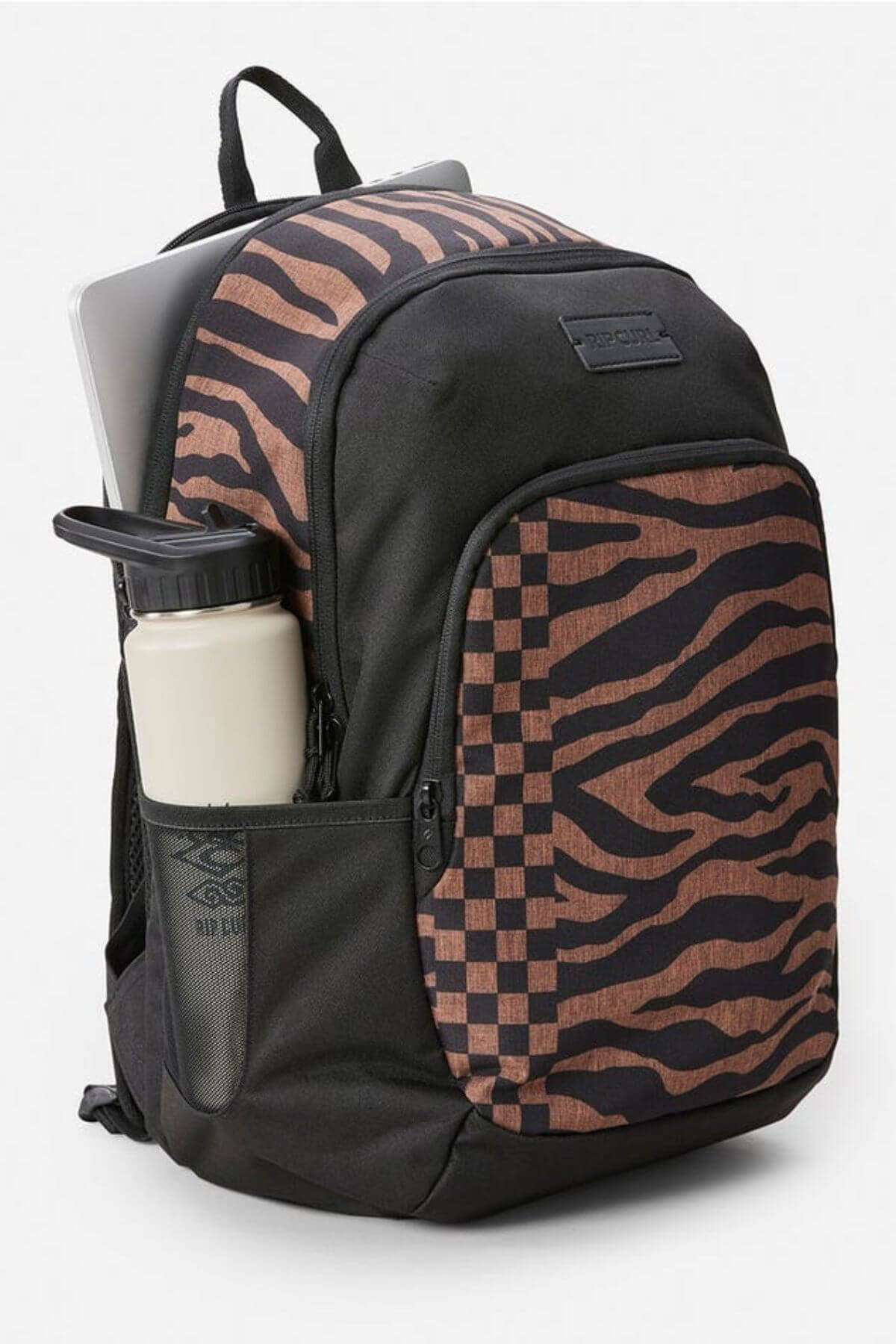 The Rip Curl Ozone 2.0 30L Backpack features a spacious black design with brown zebra and checkerboard patterns, organiser pockets, a mesh side pocket holding a cream water bottle, and a partially visible laptop in the main compartment.