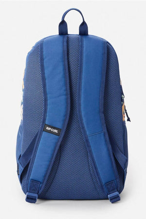 The Rip Curl Ozone 2.0 30L Backpack is shown from the back with padded mesh shoulder straps, a top handle, and a padded mesh back panel for comfort and breathability. This computer-compatible blue backpack is ideal for everyday use.