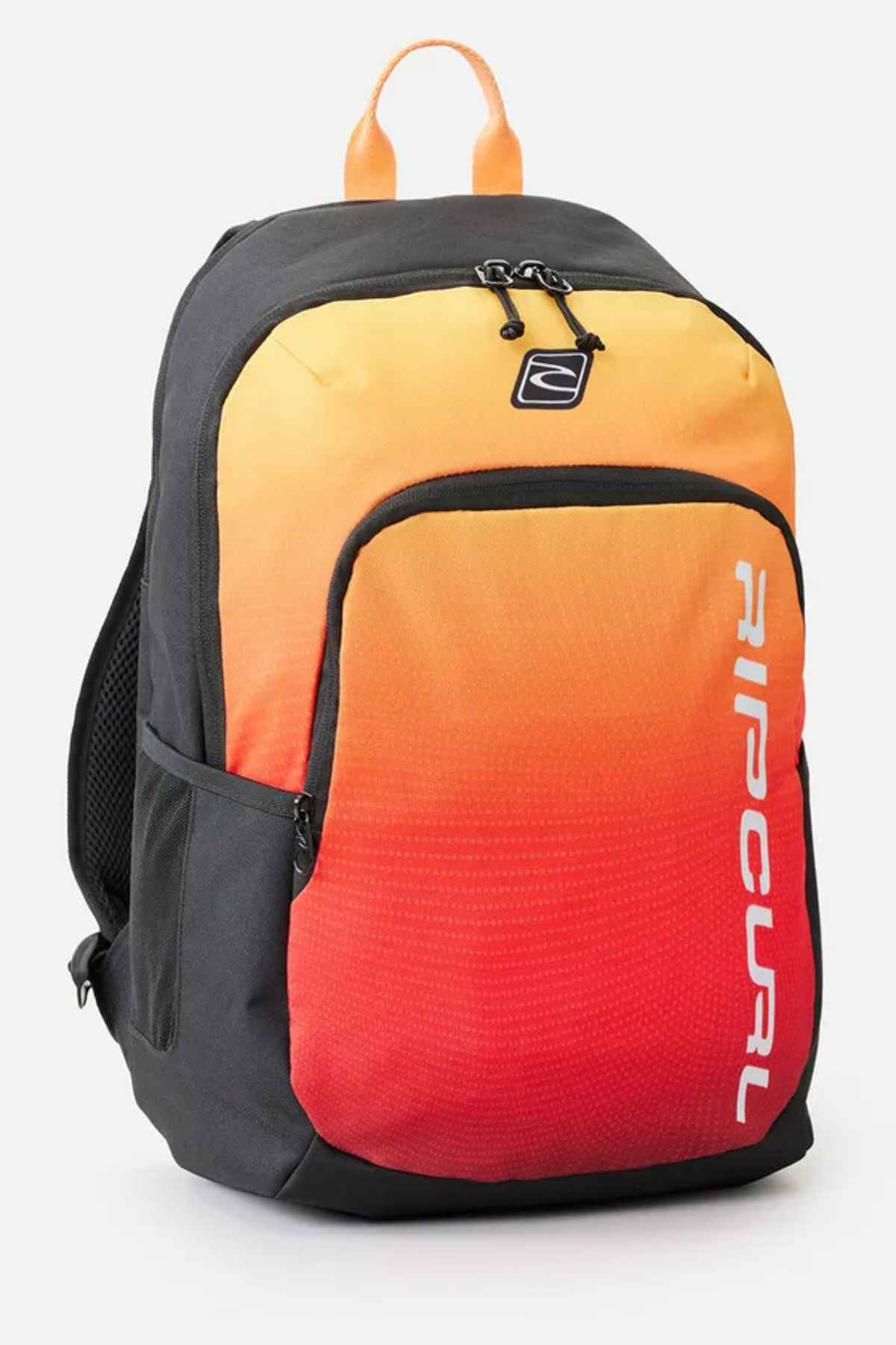 The Rip Curl Ozone 30L Back To School Backpack is ideal for students, showcasing a front pocket with a gradient from yellow to red. It features black sides, a top handle, and zippers, along with the Rip Curl logo printed vertically in white on the front.