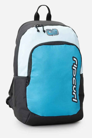 The Rip Curl Ozone 30L Back To School Backpack is ideal for school and available in black and light blue, offering a 30-liter capacity. It includes a front zip pocket, side mesh pocket, top handle, and adjustable shoulder straps. The iconic Rip Curl logo is prominently printed on the front pocket.