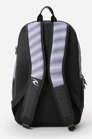 The Rip Curl Ozone 30L Faded Slant Backpack combines style with its black and grey design featuring a small white wave logo. It ensures comfort with padded, breathable mesh shoulder straps and a top handle, plus a dedicated back view laptop section for secure storage.