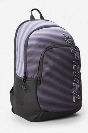 The Rip Curl Ozone 30L Faded Slant Backpack is a stylish accessory featuring "RIP CURL" on the front pocket, breathable and comfortable straps, and a sleek design with multiple compartments, including one for a laptop. Its elegant look combines light and dark gray panels effectively.