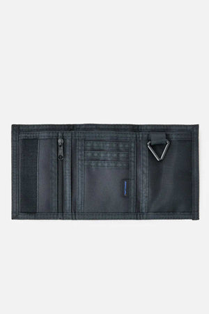 A black Rip Curl Search Surf Wallet is open on a white background, showing its tri-fold design with multiple compartments, zippered pocket, card slots, mesh pocket, and metal D-ring—ideal for beach-goers.