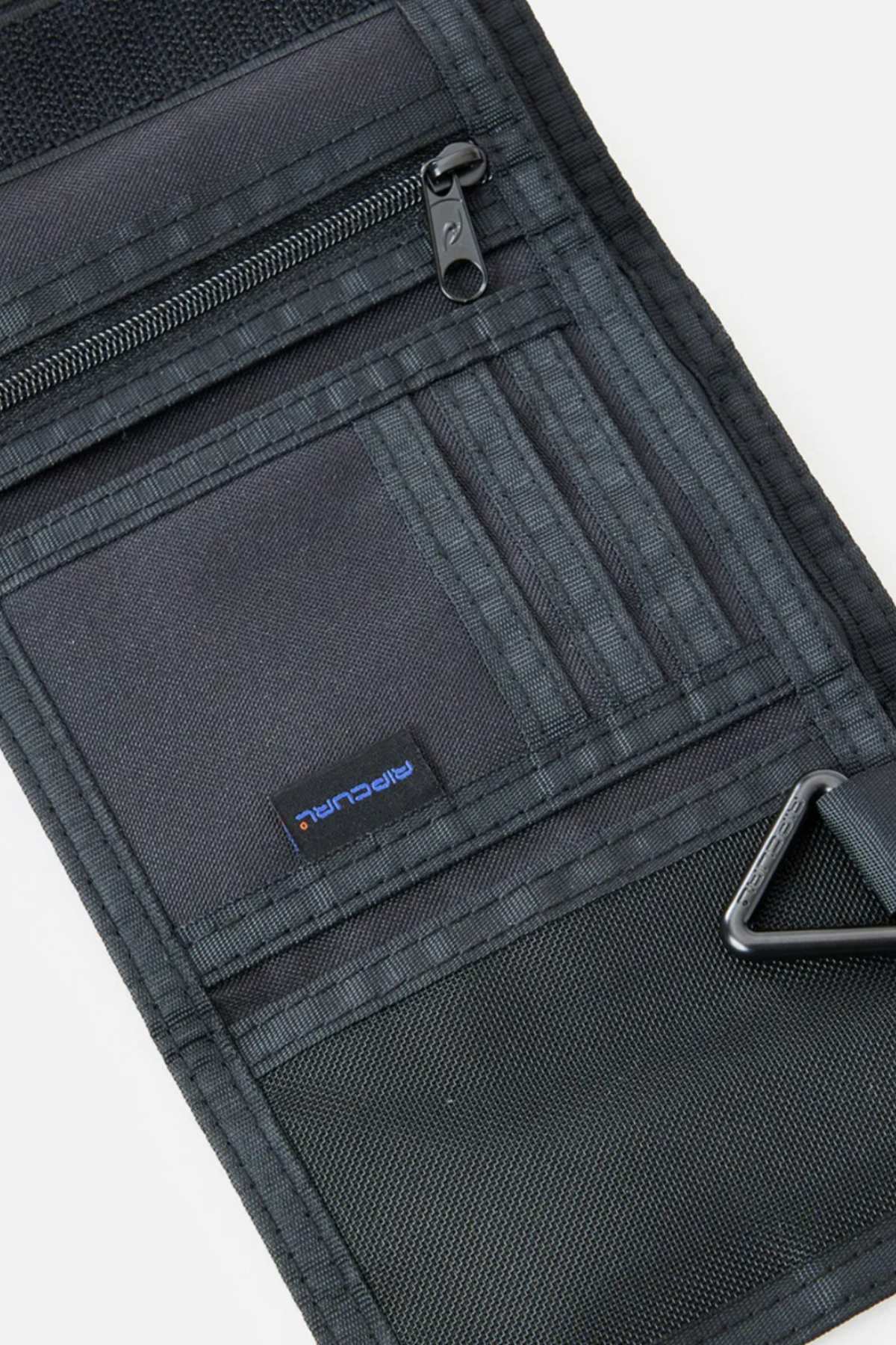 The Rip Curl Search Surf Wallet in black fabric features a tri-fold design with multiple card slots, a zippered pocket, mesh section, and a blue and black "ripcurl" label—perfect for any beach-goer’s accessory collection.