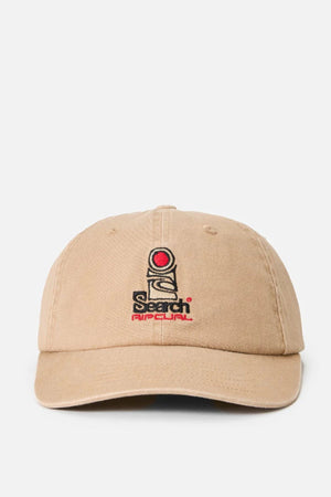 The Rip Curl Searchers SB Cap is a beige cotton twill hat with an unstructured fit, featuring an embroidered red circle, black lines, and "Search Rip Curl" text in black and red on the front. Displayed against a plain white background.