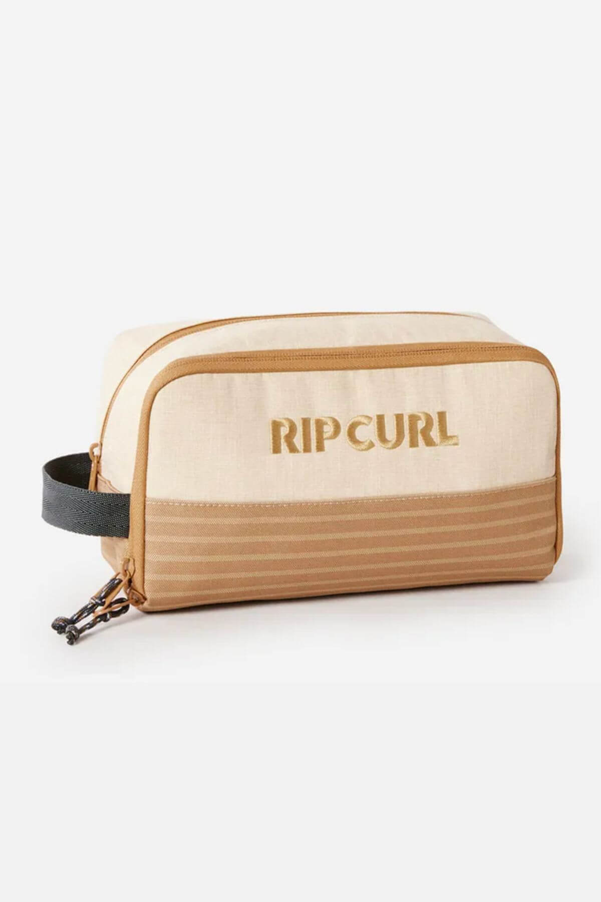 The Rip Curl Surf Revival Toiletry Bag is a beige and tan toiletry bag with a black handle, crafted from recycled polyester. It boasts a spacious, zippered main compartment and a smaller front pocket adorned with horizontal stripes. The "Rip Curl" logo is prominently displayed on the front.