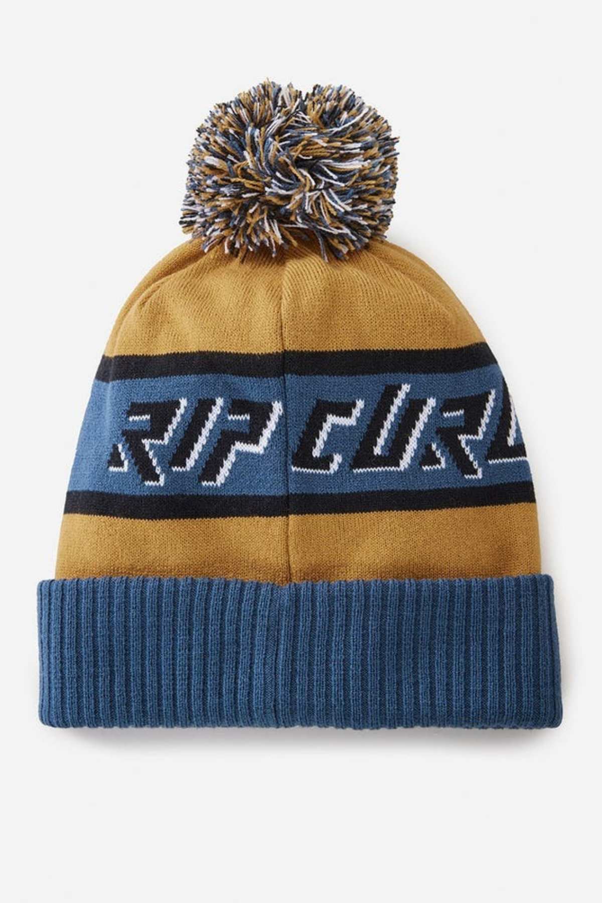 The Rip Curl Tow In Tall Beanie, in blue and mustard yellow, is made from acrylic yarn and features a playful pom-pom. It has blue cuffs and a stripe with bold "RIP CURL" lettering, making it a trendy addition to your winter wardrobe.
