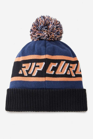 The Rip Curl Tow In Tall Beanie is a blue, black, and orange acrylic pom-pom beanie with "RIP CURL" in bold letters on the frontโa stylish choice for any season.
