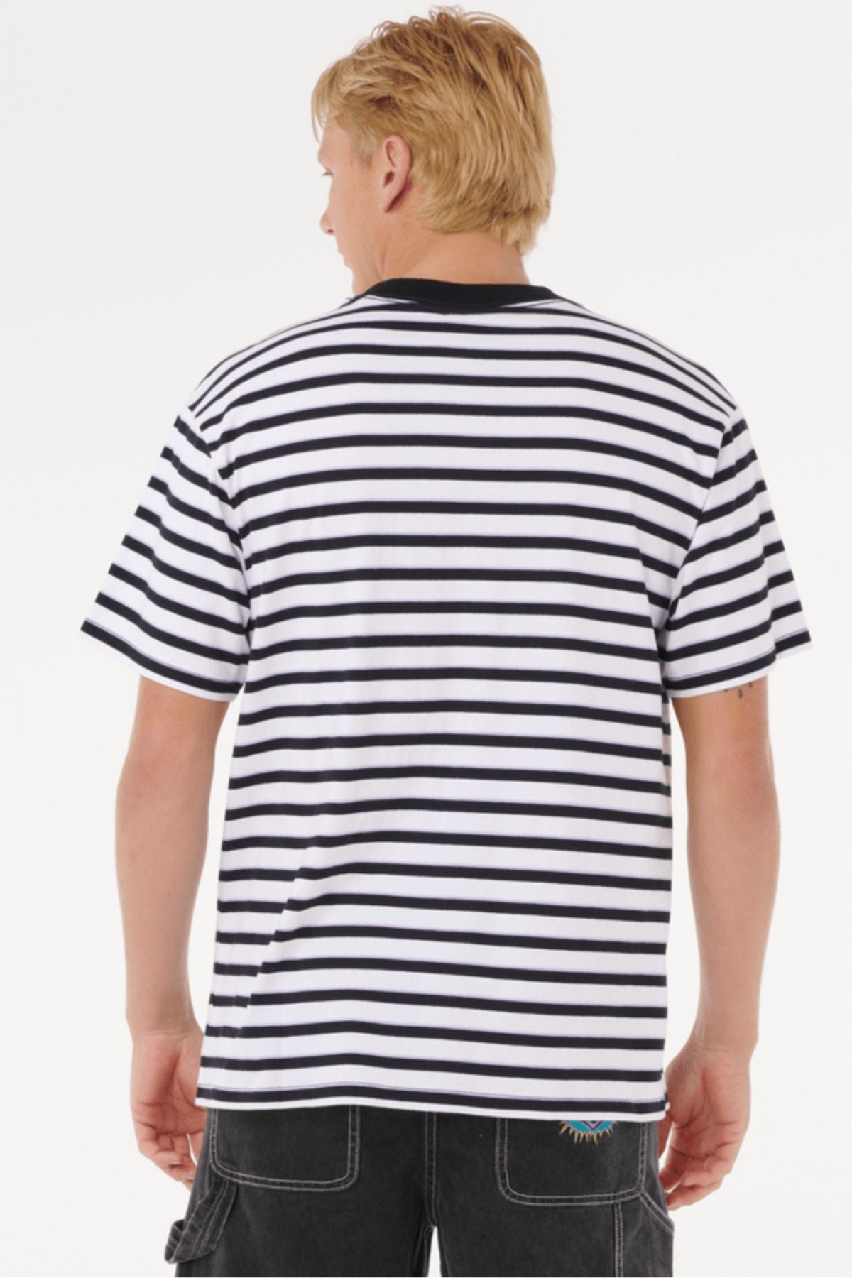 A person with short blond hair is shown from the back, wearing a Rip Curl Raw Energy Stripey Tee and black cargo shorts against a plain white background.