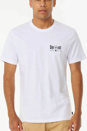 A person is wearing the Rip Curl Affinity Tee, a 100% cotton white shirt featuring a small left chest "Rip Curl" logo, paired with beige pants for a standard fit against a plain backdrop.