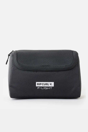 The Rip Curl F-Light Toiletry in black is a rectangular bag with a top zipper, multiple compartments, and a ventilated mesh section. It features a front logo design against a plain white background.