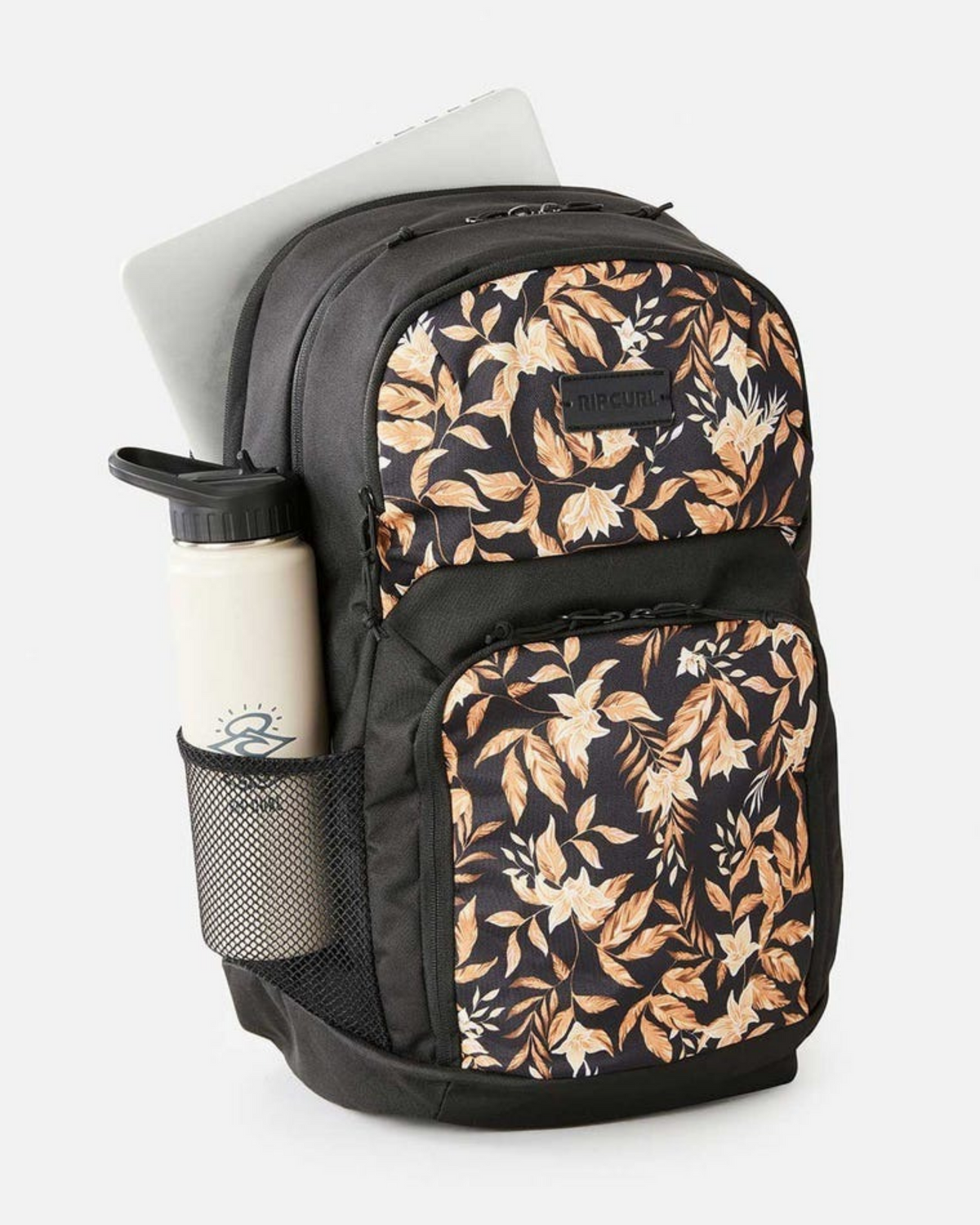 The Rip Curl Chaser 33L Backpack features a brown and white floral print, mesh side pocket for a water bottle, and a main compartment that fits a 15-inch laptop.