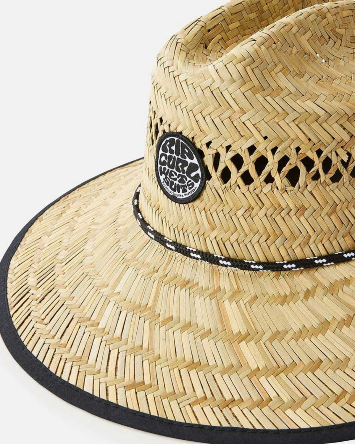The Rip Curl Logo Straw Hat has a wide brim, a black circular "Surf Club West Coast" patch, and is accented by a black and white braided band. Its crown displays a decorative woven pattern, making it ideal for sunny coastal days.