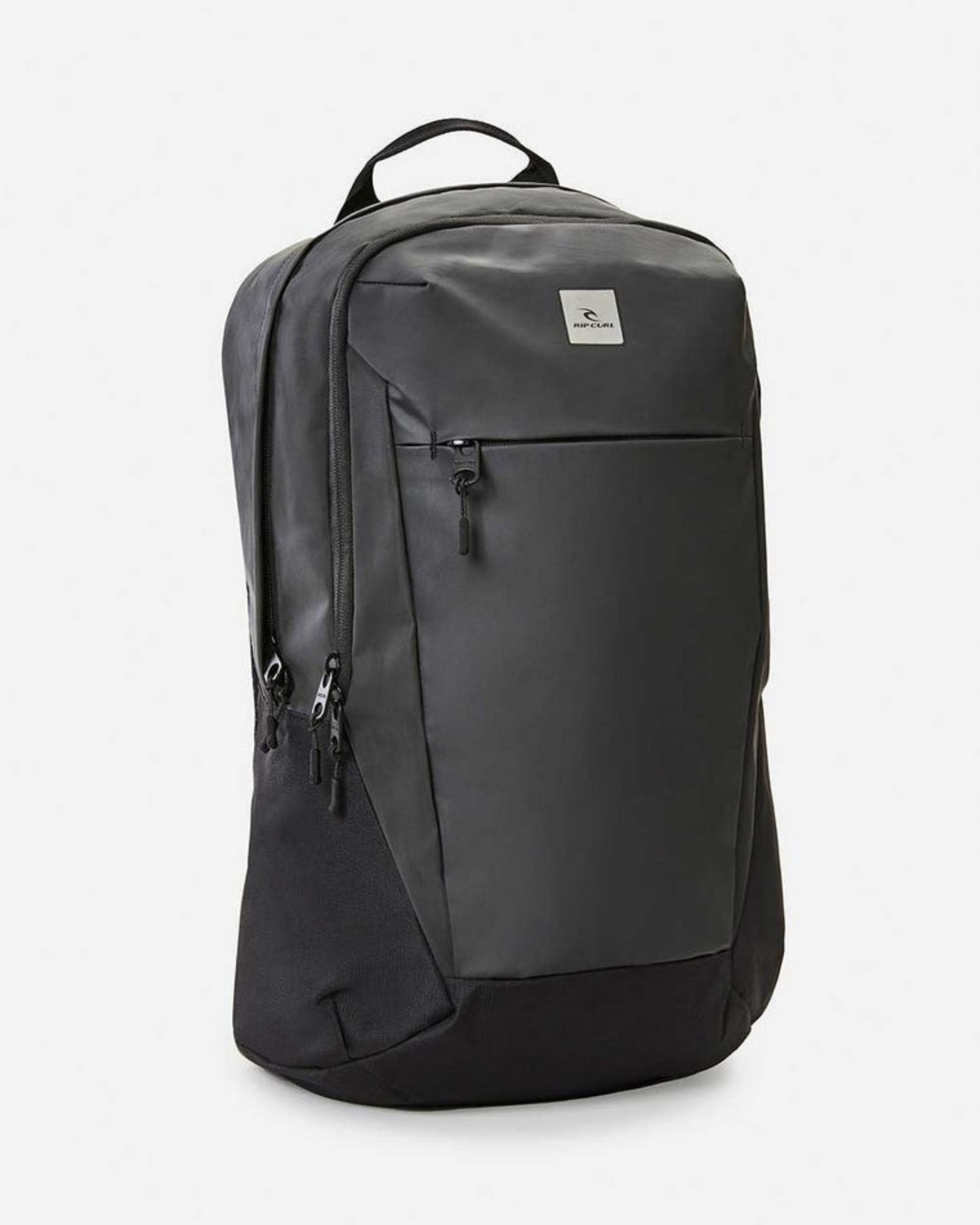 The Rip Curl Overtime 30L Backpack is a sleek black bag with a minimalist design, featuring a large front zip pocket, two side zippers, and a discreet logo. Made from recycled polyester, it has a top carrying handle and smooth texture, ideal for any adventure.