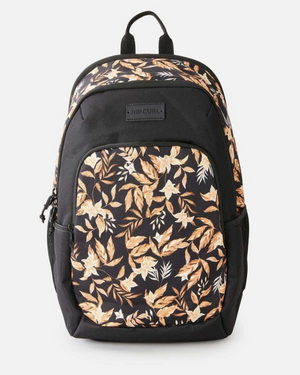 The Rip Curl Ozone 2.0 30L Backpack is made from recycled polyester and has a front pocket, top panel with a beige and light brown floral leaf design, plus a front "Rip Curl" logo label.