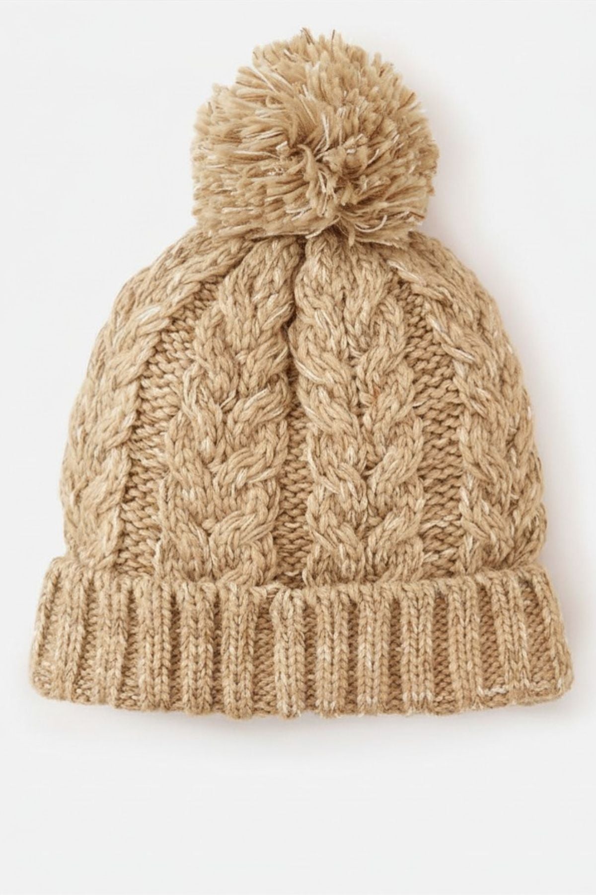 The Rip Curl Premium Reg Pom Pom Beanie is a beige cable knit hat with a folded brim, chunky pattern, and large removable pom-pom, shown on a plain white background.