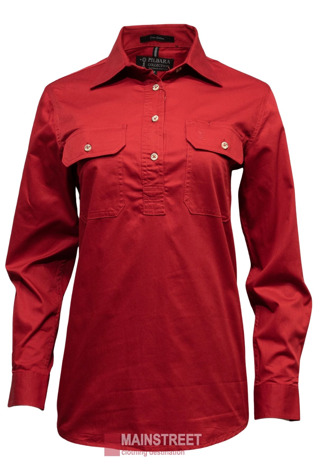 The Pilbara Ladies Long Sleeve Closed Front Shirt is a red 100% cotton women's work shirt with two chest pockets and a collar, shown on a mannequin against a white background. From Mainstreet Clothing Destination.