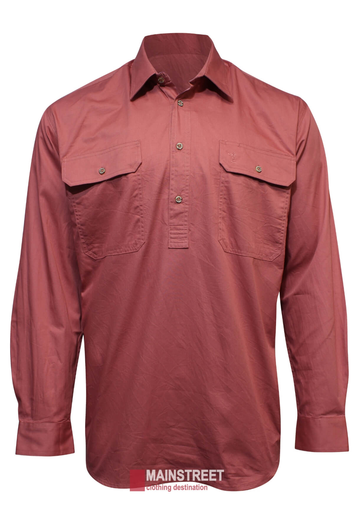 The Ritemate Pilbara Long Sleeve Closed Front Shirt is a muted red, button-up collared men's work shirt. Made from 100% cotton, it features two chest pockets with buttoned flaps and boasts an impressive UPF rating of 50+. The "Mainstreet clothing destination" logo is visible at the bottom.