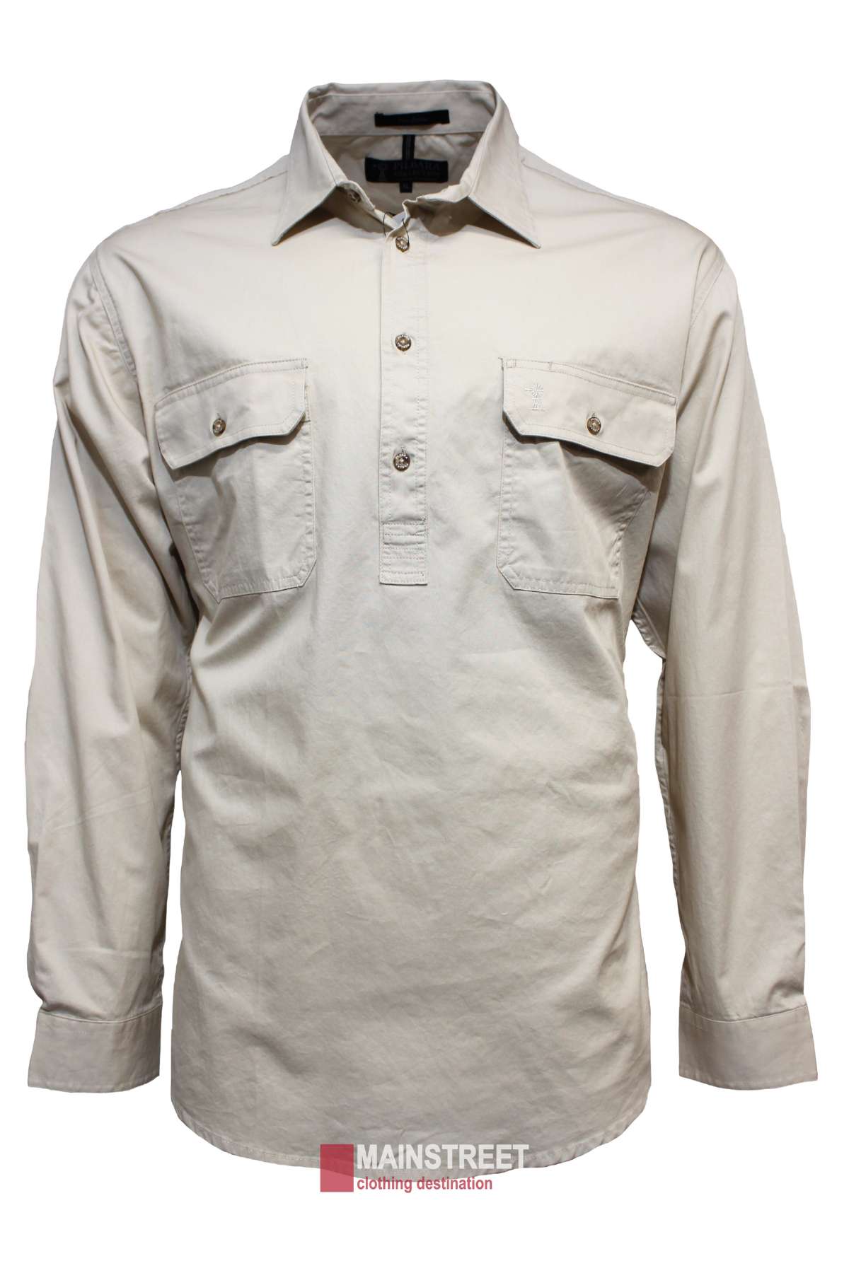 The Pilbara Heavy Weight Long Sleeve Closed Front Shirt is a beige men's work shirt with two button-flap chest pockets, open collar, UPF 50+ sun protection, and a “Mainstreet” logo at the bottom center. Displayed on a plain background.