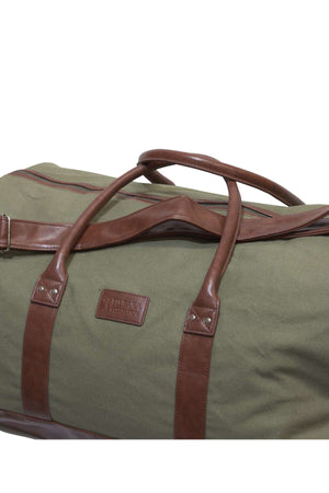 The Ritemate Pilbara Long Weekender Bag is crafted from green canvas and features brown leather handles and accents. Its quality canvas and leather construction is highlighted by a leather patch with embossed lettering, making it both sturdy and ideal for travel or weekend getaways.