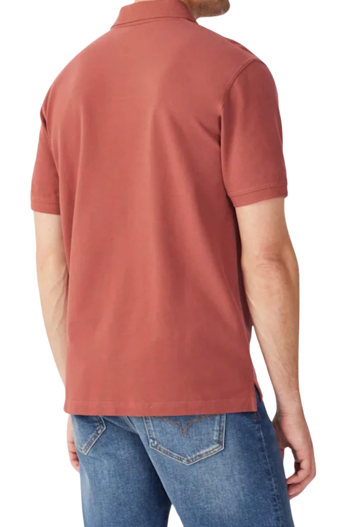 A man is shown from the back wearing a brick red RM Williams Rod Polo with short sleeves and blue jeans, showcasing the shirt’s signature style, fit, and detailed design.