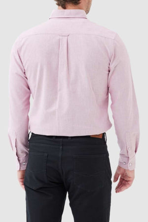 A man is seen from the back wearing the Rodd & Gunn Gunn Oxford Sports Fit Shirt in light pink (100% cotton, long sleeve) with black pants, set against a plain light gray background.