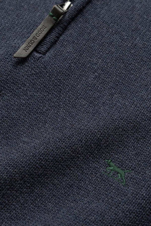 Close-up of a dark blue textured knit fabric featuring a partial premium YKK zip with a small green embroidered dog motif. The zipper pull is stamped with the text "BOBIDU CUENTIN," and the overall texture reflects the high quality characteristic of the Rodd & Gunn Merrick Bay Knit.