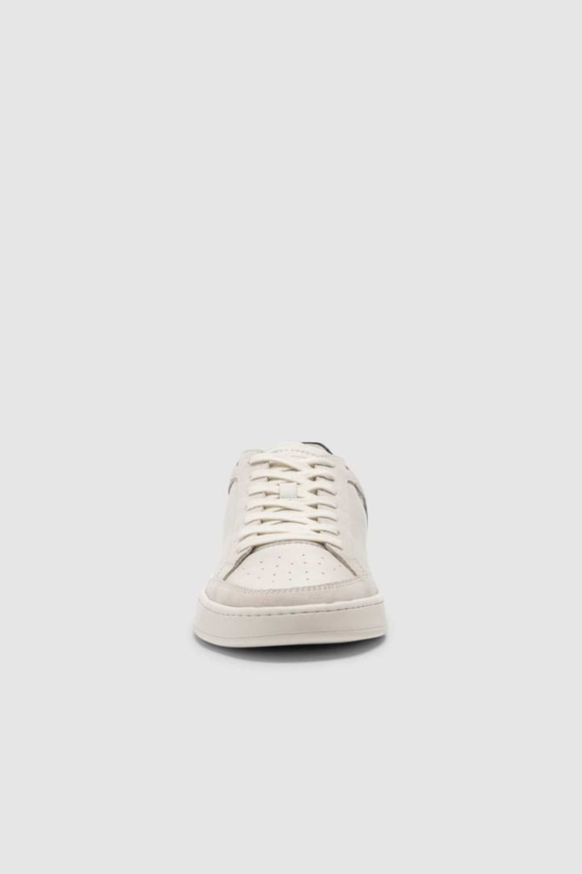 The Rodd & Gunn Sussex Street Sneaker is shown from the front against a light gray background, featuring white uppers, visible laces, perforated toe details, and a sturdy rubber outsole.