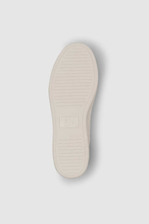 The image shows the underside of a Rodd & Gunn Sussex Street Sneaker, featuring a white rubber sole with horizontal grooves and a central rectangular logo, emphasizing its durable outsole.