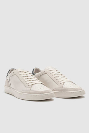 The Rodd & Gunn Sussex Street Sneaker is a white low-top with lace-up fronts, perforated toe boxes, subtle gray heel accents, and a durable rubber outsole, shown on a light gray background.