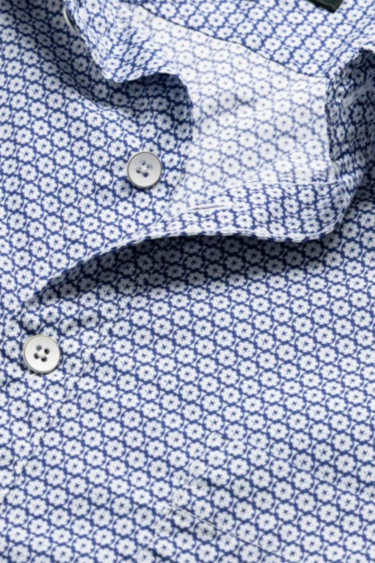 Close-up of the Rodd & Gunn Blumine Sports Fit Shirt, a slim fit 100% cotton shirt with a blue and white geometric floral print, white buttons, and a partially open collar for easy style.