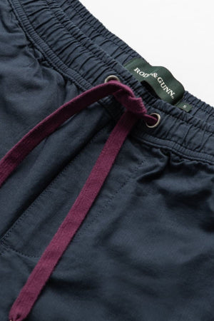 Close-up of Rodd & Gunn Resort Short in navy with deep purple drawstrings, metal eyelets, and a branded inner waistband—stylish cotton shorts designed for all-day comfort.