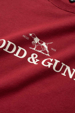 Close-up of the Rodd & Gunn Logo T-Shirt in Sports Fit shows a red design with a white dog graphic and "ODD & GUN" text, "REGD" above, and "1946" below. Made from sustainably farmed cotton, this tee offers an eco-friendly choice.