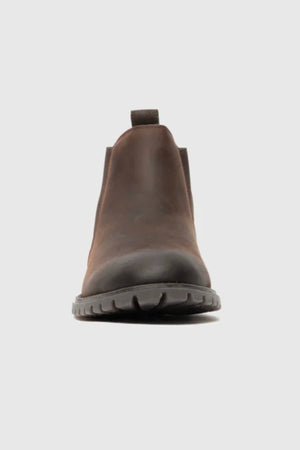 Front view of the Rodd & Gunn Clearmont Chelsea Boot in brown leather with a black rubber sole, designed for comfort, shown against a plain light gray background.