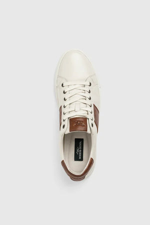 The Rodd & Gunn Endeavour Cruise Sneaker is a white leather shoe with brown accents on the tongue, heel, and side, displayed from above against a plain light gray background.