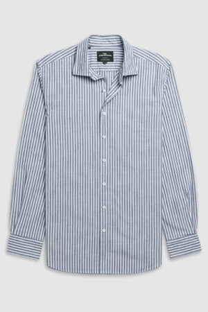 The Rodd & Gunn Fernside Sports Fit Shirt is a long-sleeve button-up with blue and white vertical stripes, made from premium European cotton. It features a classic collar, white buttons, and is shown laid flat on a light gray background.