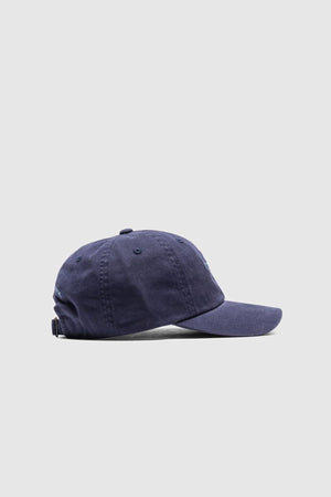 The Rodd & Gunn Gunn Cap in navy blue cotton twill is displayed from the side against a plain light gray background.